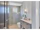 Modern bathroom with gray-scale tile, a walk-in shower, and updated vanity at 3927 Founders Club Dr, Sarasota, FL 34240