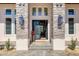 Elegant entryway with stone pillars and modern door at 3927 Founders Club Dr, Sarasota, FL 34240