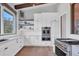 Modern kitchen featuring white cabinetry, stainless steel appliances, and hardwood floors at 3927 Founders Club Dr, Sarasota, FL 34240