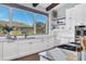 Modern kitchen with white cabinets, stainless steel appliances, and farmhouse sink at 3927 Founders Club Dr, Sarasota, FL 34240