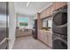 Laundry room with hexagon tile floor, modern appliances, and ample storage at 3927 Founders Club Dr, Sarasota, FL 34240