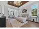 Spacious main bedroom with wood floors, sitting area, and coffered ceiling at 3927 Founders Club Dr, Sarasota, FL 34240