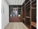 Large walk-in closet with dark wood custom built-ins at 3927 Founders Club Dr, Sarasota, FL 34240