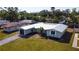 An elevated view of a cozy single-story home featuring a crisp white roof and well-kept lawn at 3952 Coleridge Pl, Sarasota, FL 34241