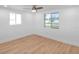 Bedroom featuring laminate flooring, neutral paint, and updated ceiling fan at 3952 Coleridge Pl, Sarasota, FL 34241