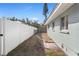 Side yard features a white vinyl fence and a grassy area at 3952 Coleridge Pl, Sarasota, FL 34241