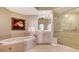 Spa-like bathroom with soaking tub, walk-in shower, and double vanity at 401 N Point Rd # 401, Osprey, FL 34229