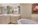 Bathroom with corner soaking tub and double vanity at 401 N Point Rd # 401, Osprey, FL 34229