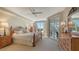 Main bedroom with wood furniture, balcony access, and ample natural light at 401 N Point Rd # 401, Osprey, FL 34229