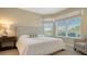 Guest bedroom with a king-size bed and large windows at 401 N Point Rd # 401, Osprey, FL 34229