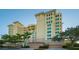 Upscale condo building featuring a grand entrance and palm trees at 401 N Point Rd # 401, Osprey, FL 34229