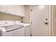 Laundry room with washer, dryer, and cabinets at 401 N Point Rd # 401, Osprey, FL 34229