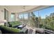 Relaxing screened balcony with wicker furniture and tranquil nature views at 401 N Point Rd # 401, Osprey, FL 34229