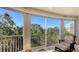 Enjoy serene nature views from this screened balcony with comfortable seating at 401 N Point Rd # 401, Osprey, FL 34229