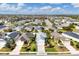 Aerial view of a neighborhood featuring houses with green lawns and palm trees at 4121 Deep Creek Ter, Parrish, FL 34219