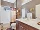 Clean bathroom with a shower/tub combo, wood vanity, and palm-themed decor at 4121 Deep Creek Ter, Parrish, FL 34219