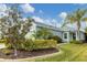 Single-story home with light green exterior, landscaping, and palm trees at 4121 Deep Creek Ter, Parrish, FL 34219