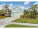 House exterior showcasing a light green facade and two-car garage at 4121 Deep Creek Ter, Parrish, FL 34219