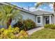 Front entrance with walkway, landscaping, and palm trees at 4121 Deep Creek Ter, Parrish, FL 34219