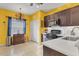 Well-equipped kitchen with dark wood cabinets and white countertops at 4121 Deep Creek Ter, Parrish, FL 34219