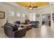 Living room with comfortable seating, a view to the kitchen, and a yellow ceiling at 4121 Deep Creek Ter, Parrish, FL 34219