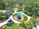 Community playground with play structures, shaded by palm trees at 4121 Deep Creek Ter, Parrish, FL 34219