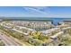 Aerial view of waterfront community; buildings, parking, and ocean visible at 4350 Chatham Dr # E106, Longboat Key, FL 34228