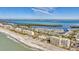 Aerial view of beachfront community with ocean and residential buildings at 4350 Chatham Dr # E106, Longboat Key, FL 34228