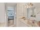 Clean bathroom with a vanity, sink, and a view into the bedroom at 4350 Chatham Dr # 106, Longboat Key, FL 34228