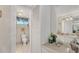 Bathroom features a toilet and a vanity with a sink and mirror at 4350 Chatham Dr # 106, Longboat Key, FL 34228