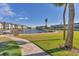 Complex exterior showing manicured lawn and waterfront access at 4350 Chatham Dr # E106, Longboat Key, FL 34228