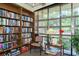 Quiet community library with bookshelves and comfy chair at 4350 Chatham Dr # E106, Longboat Key, FL 34228