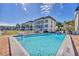 Inviting community pool with surrounding patio furniture at 4350 Chatham Dr # 106, Longboat Key, FL 34228