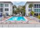 Community pool and patio area with surrounding buildings at 4350 Chatham Dr # E106, Longboat Key, FL 34228