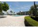 Community pool with brick patio and lounge chairs at 4350 Chatham Dr # 106, Longboat Key, FL 34228