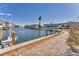 Brick paved pathway alongside canal; boats docked, waterfront homes visible at 4350 Chatham Dr # 106, Longboat Key, FL 34228