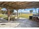 Covered patio with built-in grill, overlooking the pool and waterfront at 4511 7Th Street E Ct, Ellenton, FL 34222