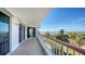 Spacious balcony overlooking the ocean and palm trees at 455 Longboat Club Rd # 305, Longboat Key, FL 34228