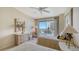 Guest bedroom with twin beds and access to a balcony with ocean view at 455 Longboat Club Rd # 305, Longboat Key, FL 34228