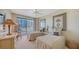 Bright bedroom with twin beds, balcony access, and ocean view at 455 Longboat Club Rd # 305, Longboat Key, FL 34228