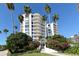 Coastal condo building with lush landscaping and walkway at 455 Longboat Club Rd # 305, Longboat Key, FL 34228