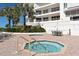 Relaxing community hot tubs with surrounding patio furniture at 455 Longboat Club Rd # 305, Longboat Key, FL 34228