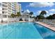 Inviting community pool with surrounding lounge chairs at 455 Longboat Club Rd # 305, Longboat Key, FL 34228