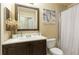 Clean bathroom with a vanity, toilet, shower, and decorative art at 4850 51St W St # 9106, Bradenton, FL 34210