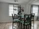 Bright dining area with glass table and four chairs at 4915 Winged Foot Ave, Sarasota, FL 34234