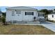 Single-wide mobile home with landscaped yard at 4915 Winged Foot Ave, Sarasota, FL 34234