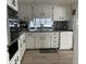 White kitchen with dark countertops and modern appliances at 4915 Winged Foot Ave, Sarasota, FL 34234