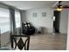 Living room with gray vinyl flooring, comfy chair, and large windows at 4915 Winged Foot Ave, Sarasota, FL 34234