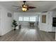 Open living room with wood-look flooring and access to sunroom at 4915 Winged Foot Ave, Sarasota, FL 34234