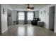 Bright living room with gray vinyl flooring and ceiling fan at 4915 Winged Foot Ave, Sarasota, FL 34234